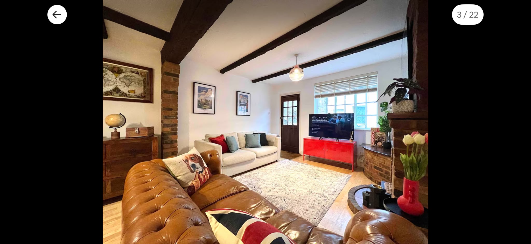 Comfortable living room with leather chesterfield sofa and exposed beams